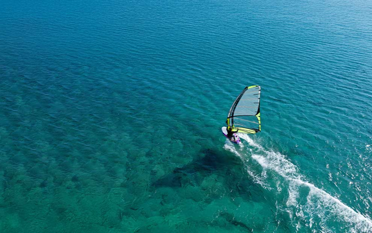 Windsurfing on the crystal-clear waters of Corsica
